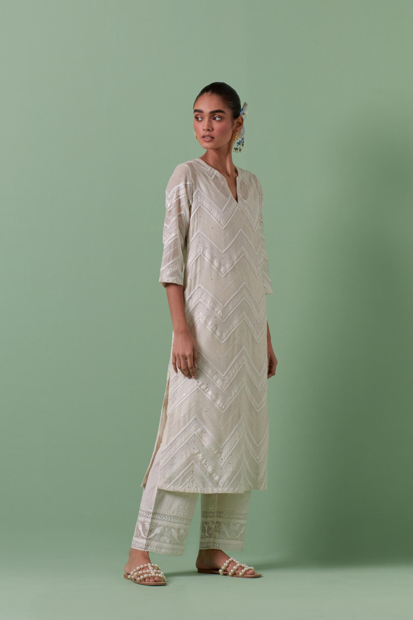 Off-white cotton chanderi straight kurta set with all over chevron pattern. It is embellished with silk patchwork, thread, sequins and mirrors.