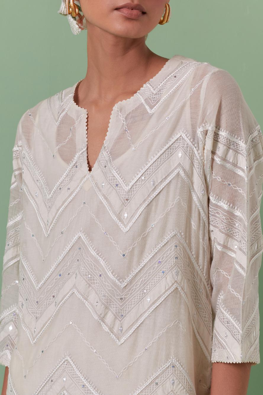 Off-white cotton chanderi straight kurta set with all over chevron pattern. It is embellished with silk patchwork, thread, sequins and mirrors.