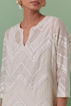 Off-white cotton chanderi straight kurta set with all over chevron pattern. It is embellished with silk patchwork, thread, sequins and mirrors.
