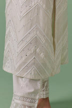Off-white cotton chanderi straight kurta set with all over chevron pattern. It is embellished with silk patchwork, thread, sequins and mirrors.