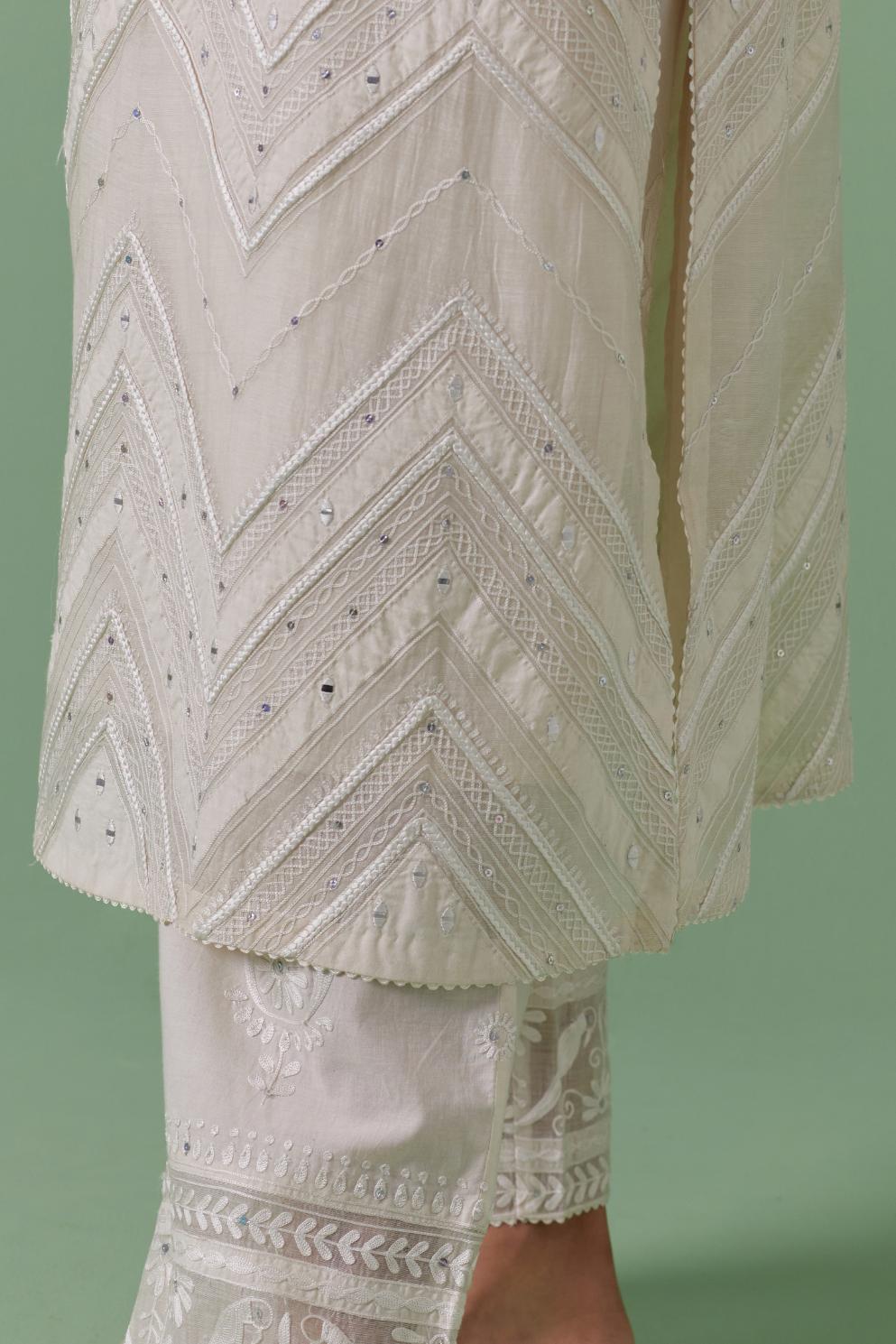 Off-white cotton chanderi straight kurta set with all over chevron pattern. It is embellished with silk patchwork, thread, sequins and mirrors.