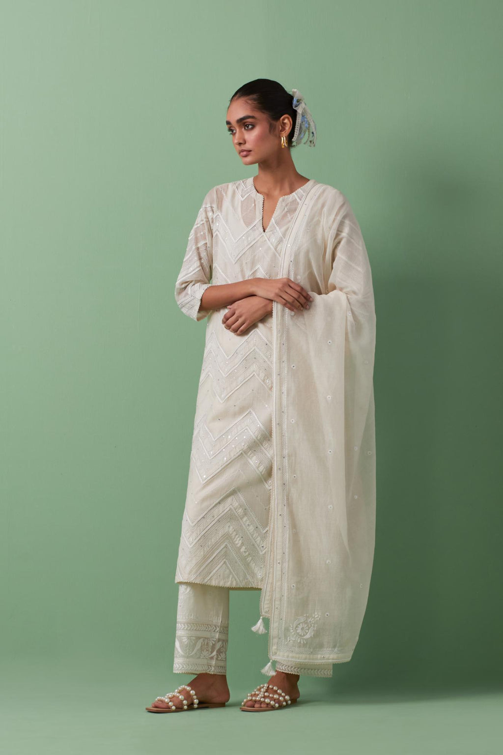 Off-white cotton chanderi straight kurta set with all over chevron pattern. It is embellished with silk patchwork, thread, sequins and mirrors.