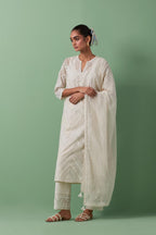 Off-white cotton chanderi straight kurta set with all over chevron pattern. It is embellished with silk patchwork, thread, sequins and mirrors.