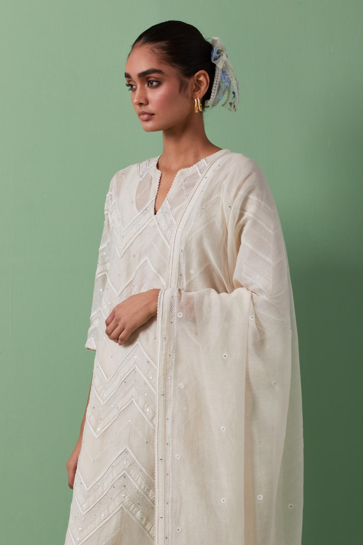 Off-white cotton chanderi dupatta with delicate silk thread embroidery, highlighted with braids, mirrors and sequins work.
