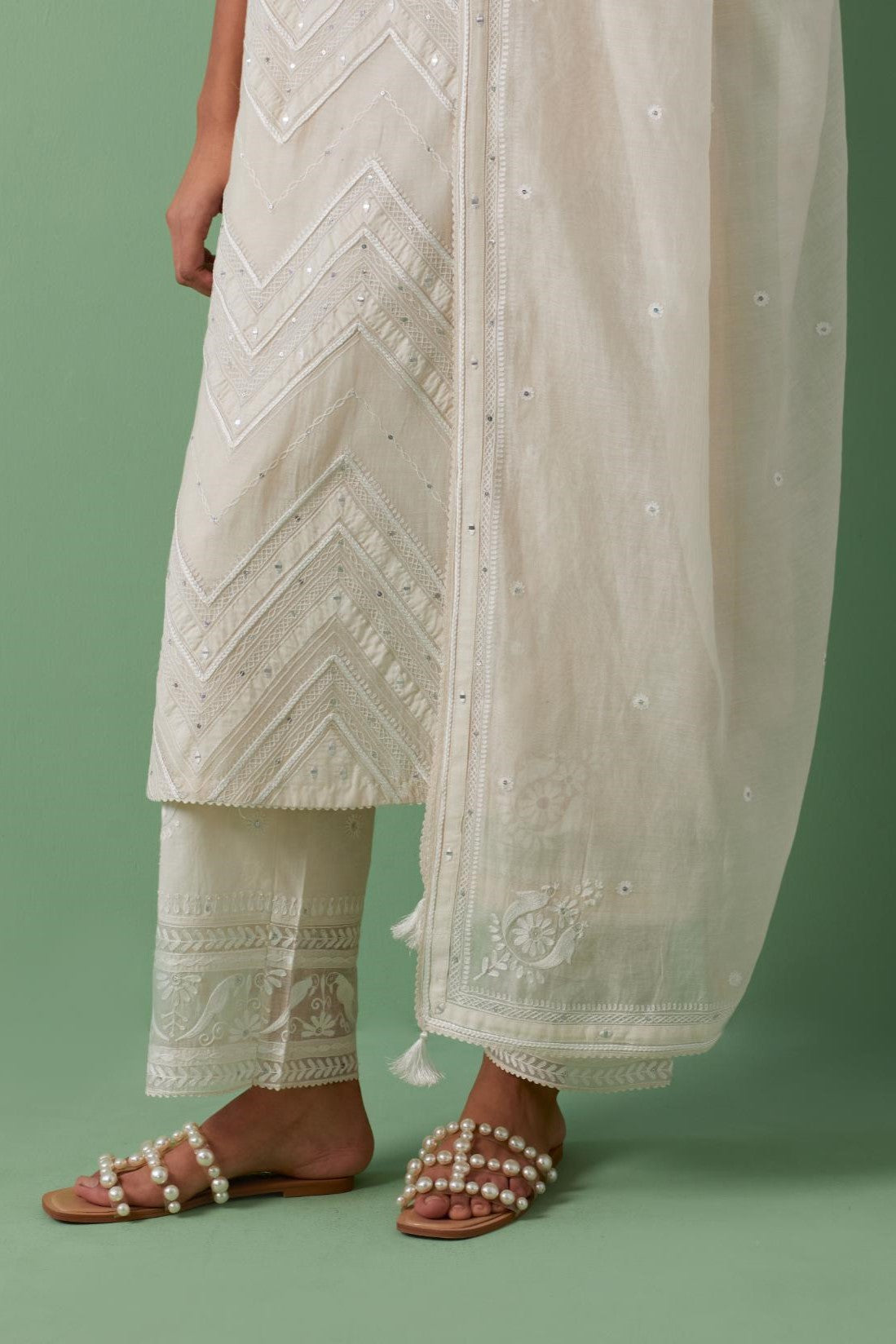 Off-white cotton chanderi dupatta with delicate silk thread embroidery, highlighted with braids, mirrors and sequins work.