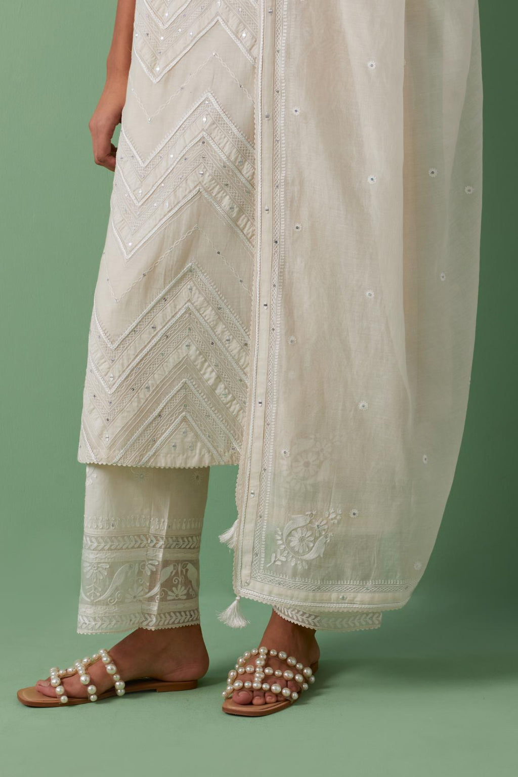 Off-white cotton chanderi straight kurta set with all over chevron pattern. It is embellished with silk patchwork, thread, sequins and mirrors.