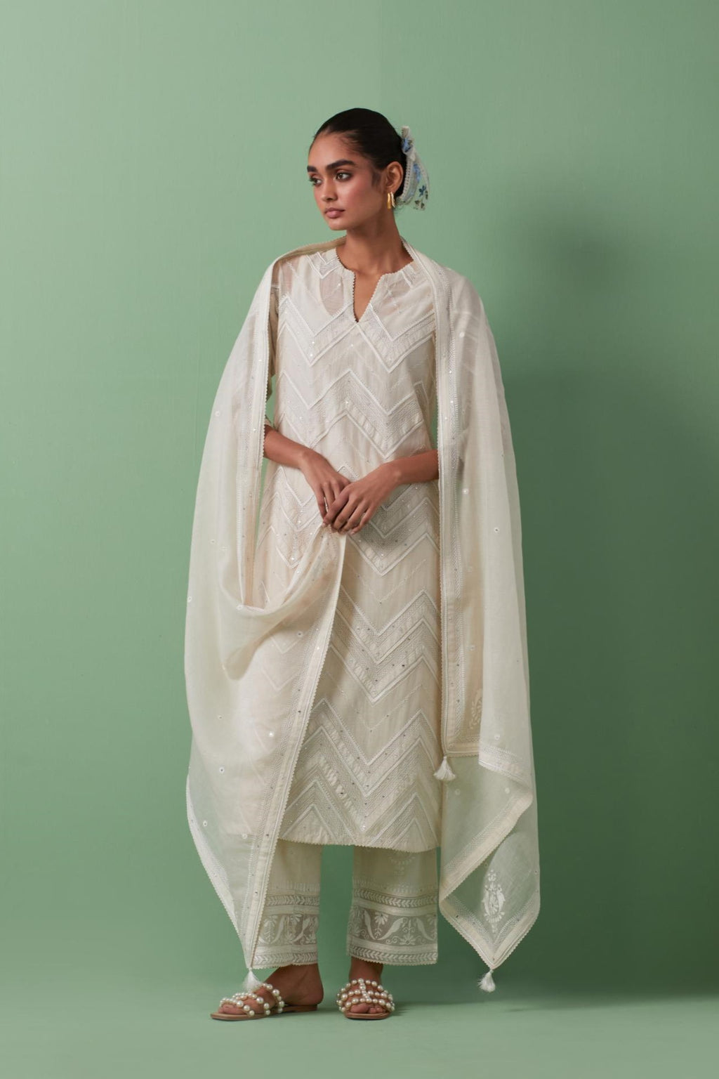 Off-white cotton chanderi dupatta with delicate silk thread embroidery, highlighted with braids, mirrors and sequins work.