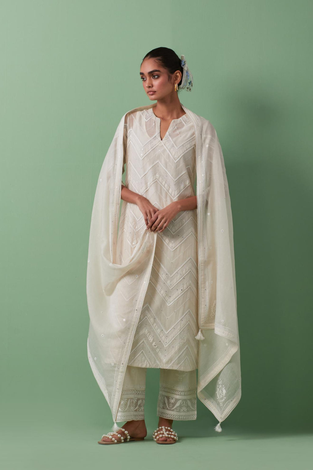 Off-white cotton chanderi straight kurta set with all over chevron pattern. It is embellished with silk patchwork, thread, sequins and mirrors.