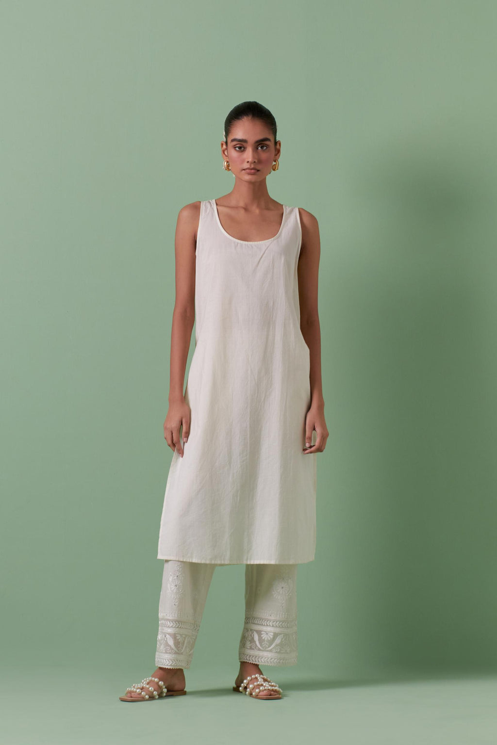 Off-white cotton chanderi straight kurta set with all over chevron pattern. It is embellished with silk patchwork, thread, sequins and mirrors.