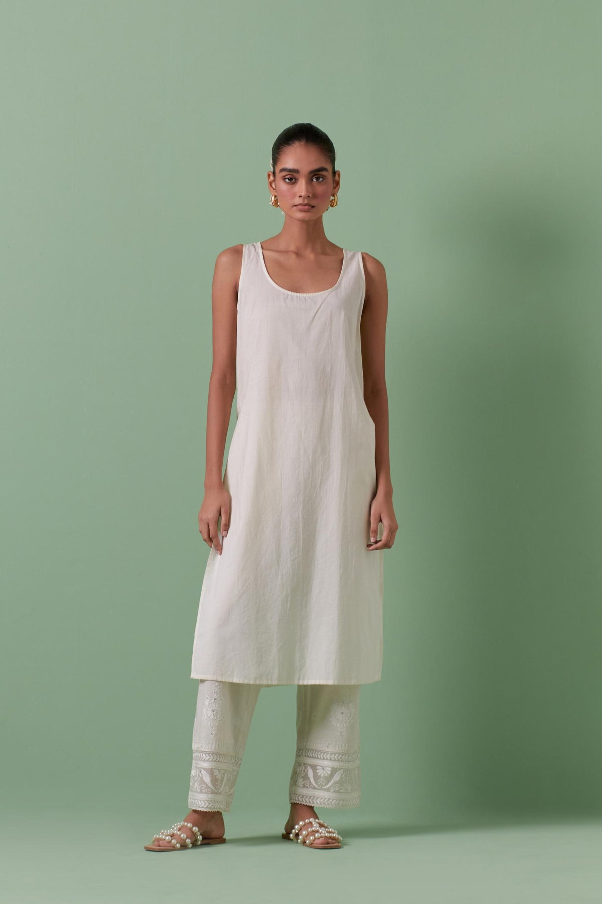 Off-white cotton chanderi straight kurta set with all over chevron pattern. It is embellished with silk patchwork, thread, sequins and mirrors.