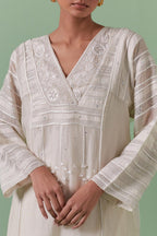 Off-white cotton chanderi easy fit long kaftan detailed with patch, silk thread, mirror & sequins work, paired with off white cotton straight pants with all over off white silk thread embroidery detailed with sequins.