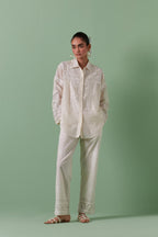 Off-white cotton chanderi embroidered shirt with full sleeves, paired with off white cotton straight pants with all over off white color embroidery detailed with sequins.