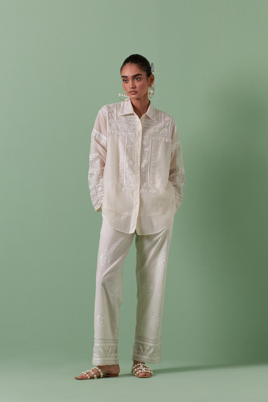 Off-white cotton chanderi embroidered shirt with full sleeves, paired with off white cotton straight pants with all over off white color embroidery detailed with sequins.