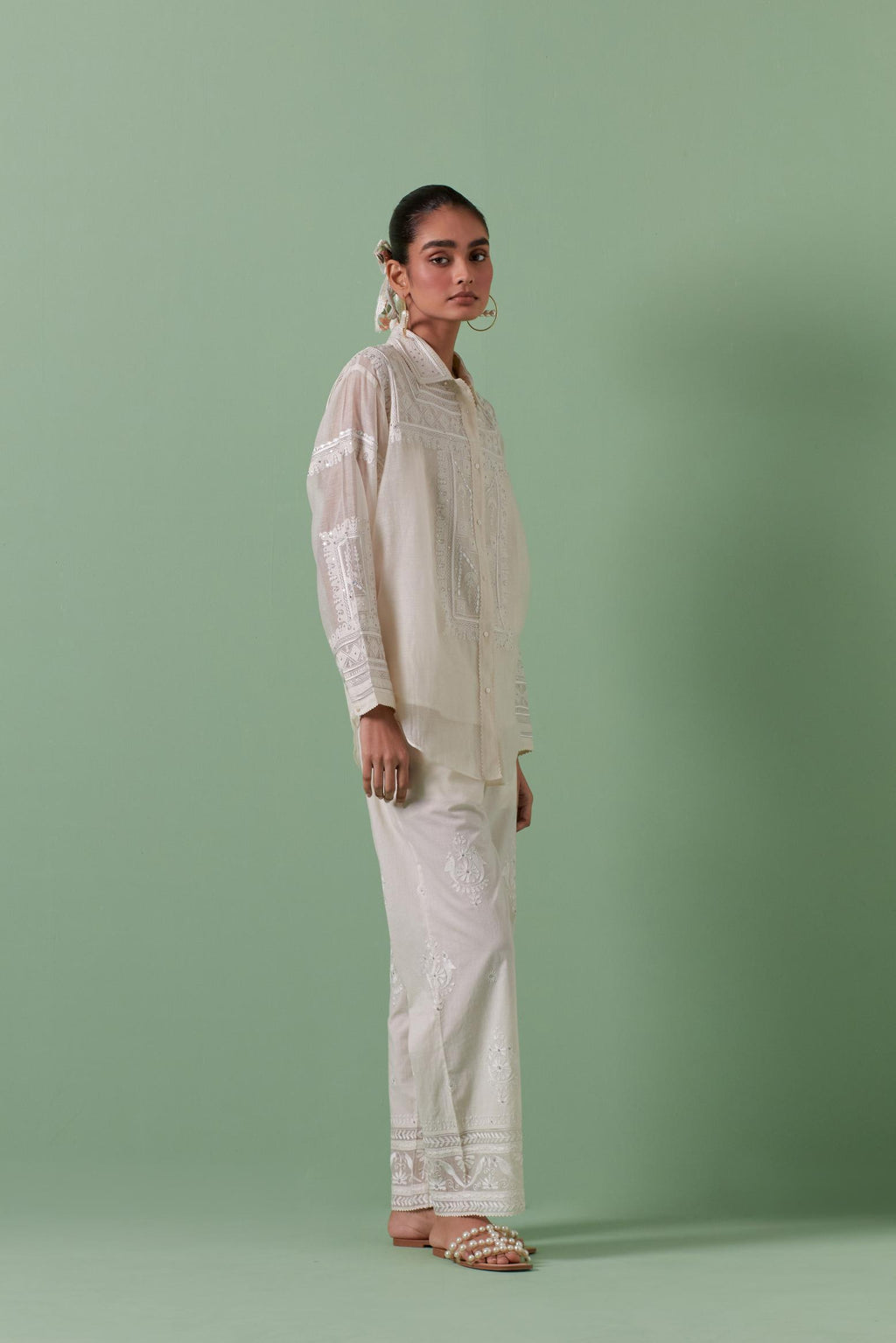 Off-white cotton chanderi embroidered shirt with full sleeves, paired with off white cotton straight pants with all over off white color embroidery detailed with sequins.