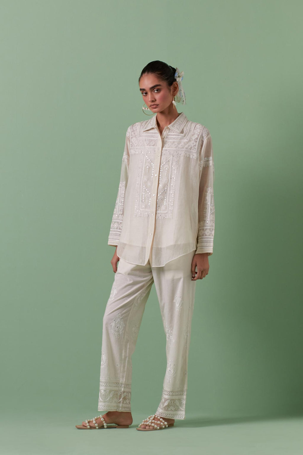 Off-white cotton chanderi embroidered shirt with full sleeves, paired with off white cotton straight pants with all over off white color embroidery detailed with sequins.