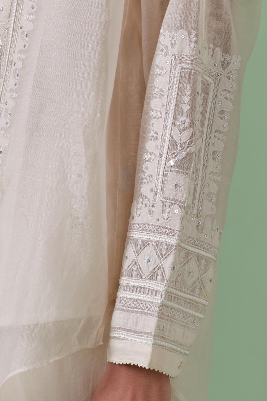 Off-white cotton chanderi embroidered shirt with full sleeves, paired with off white cotton straight pants with all over off white color embroidery detailed with sequins.