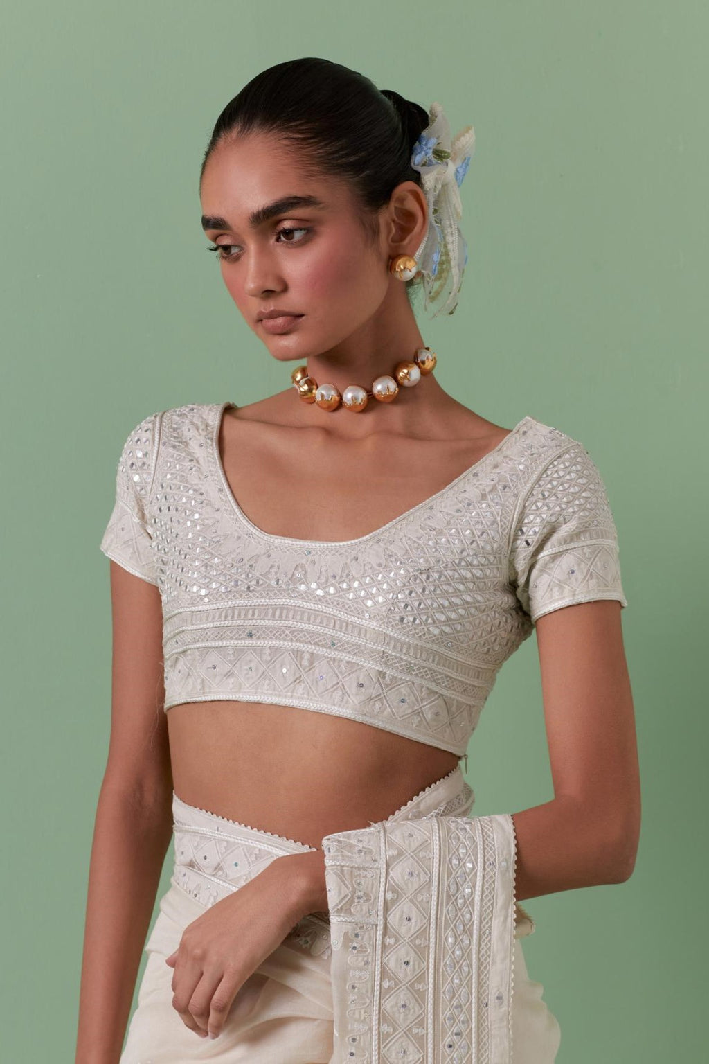 Off white cotton chanderi embroidered blouse with deep round neck and princess seams.