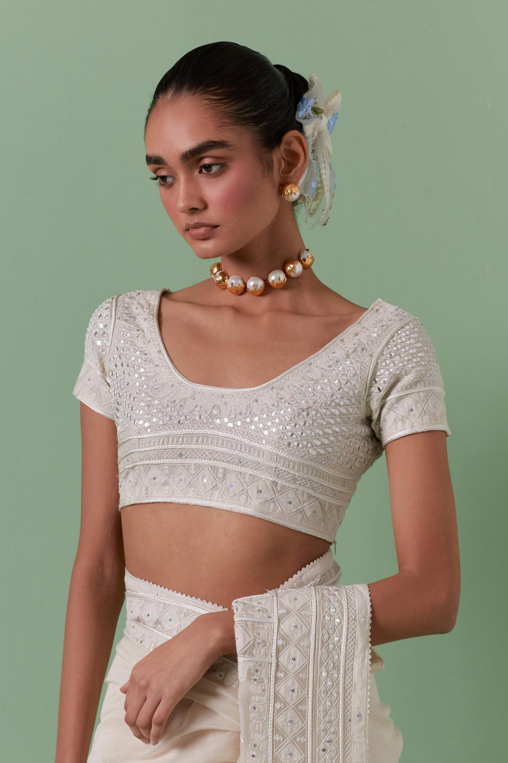 Off-white cotton chanderi saree with delicate silk thread embroidery, highlighted with braids, mirrors and sequins, paired with off white cotton chanderi embroidered blouse with deep round neck and princess seams.