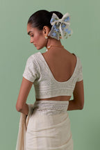 Off white cotton chanderi embroidered blouse with deep round neck and princess seams.