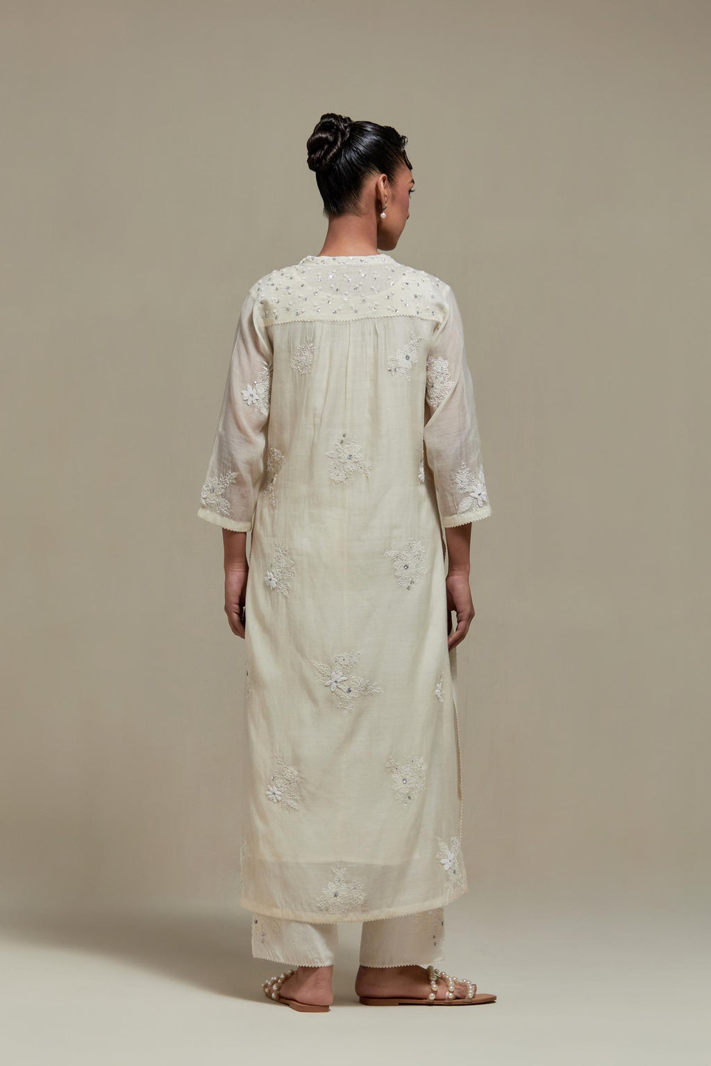 Off white cotton Chanderi straight kurta set with randomly placed appliquéd flowers, highlighted with sequins and beads.