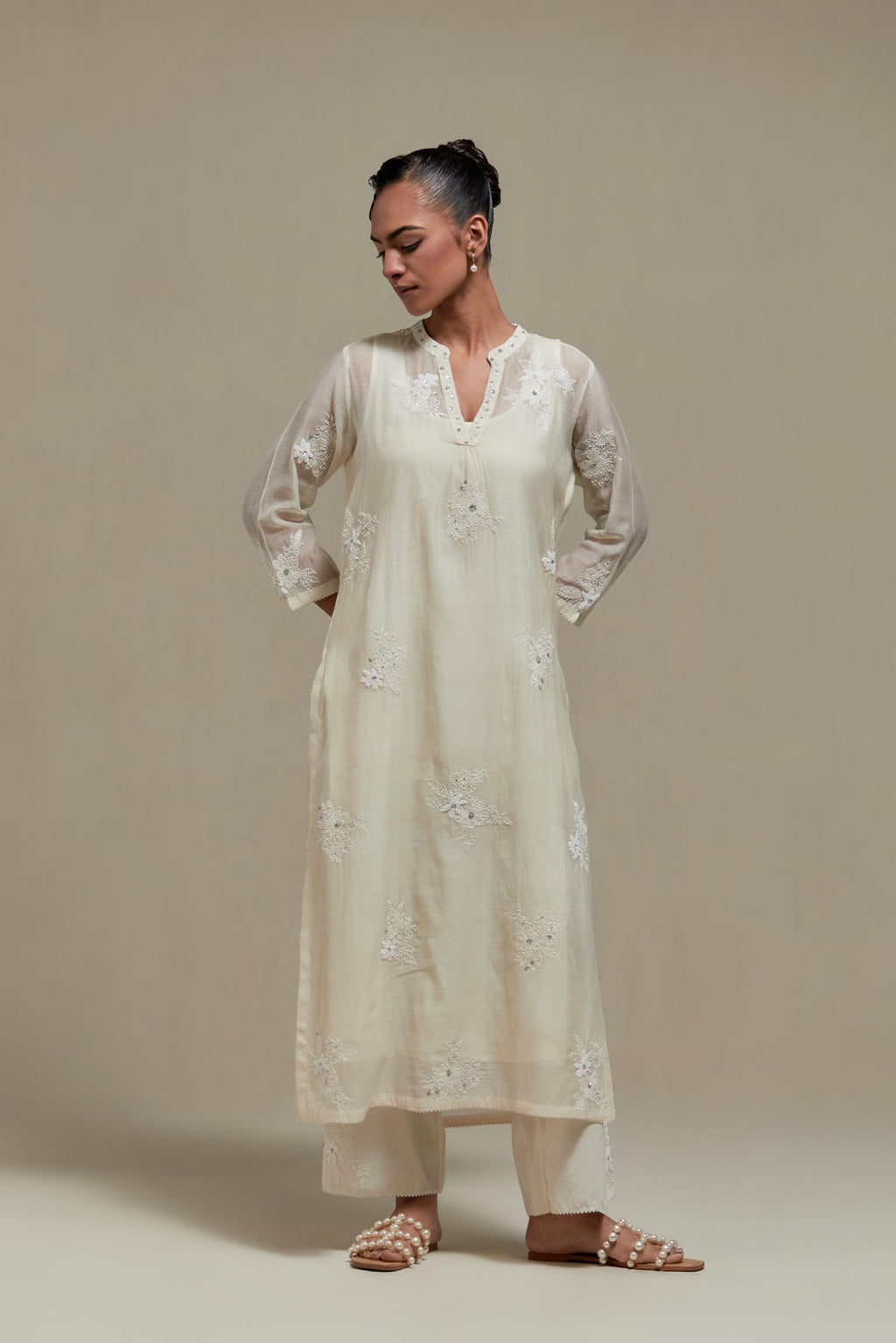 Off white cotton Chanderi straight kurta set with randomly placed appliquéd flowers, highlighted with sequins and beads.