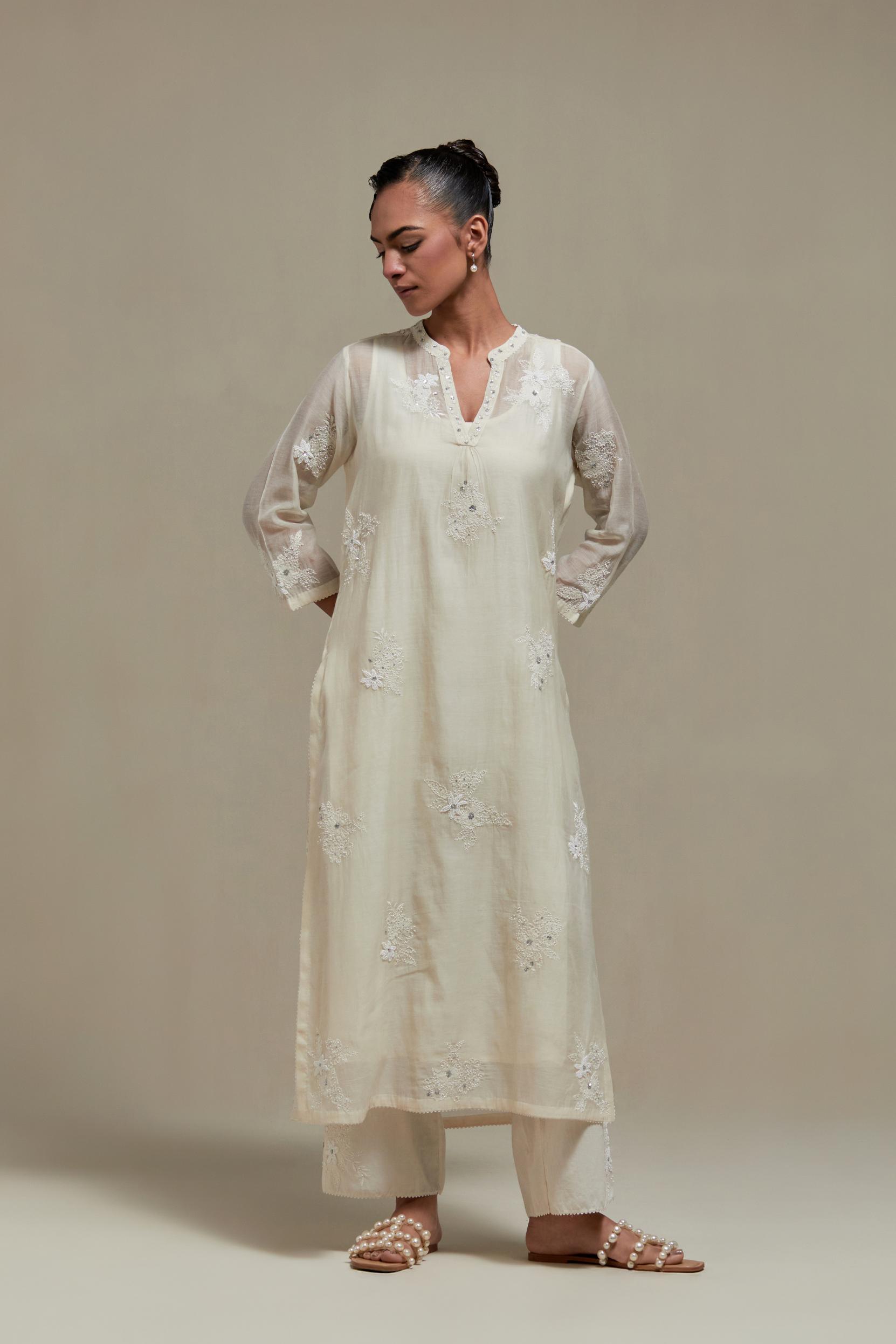 Off white cotton Chanderi straight kurta set with randomly placed appliquéd flowers, highlighted with sequins and beads.