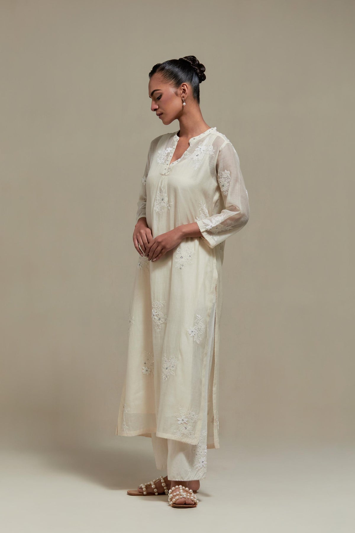 Off white cotton Chanderi straight kurta set with randomly placed appliquéd flowers, highlighted with sequins and beads.