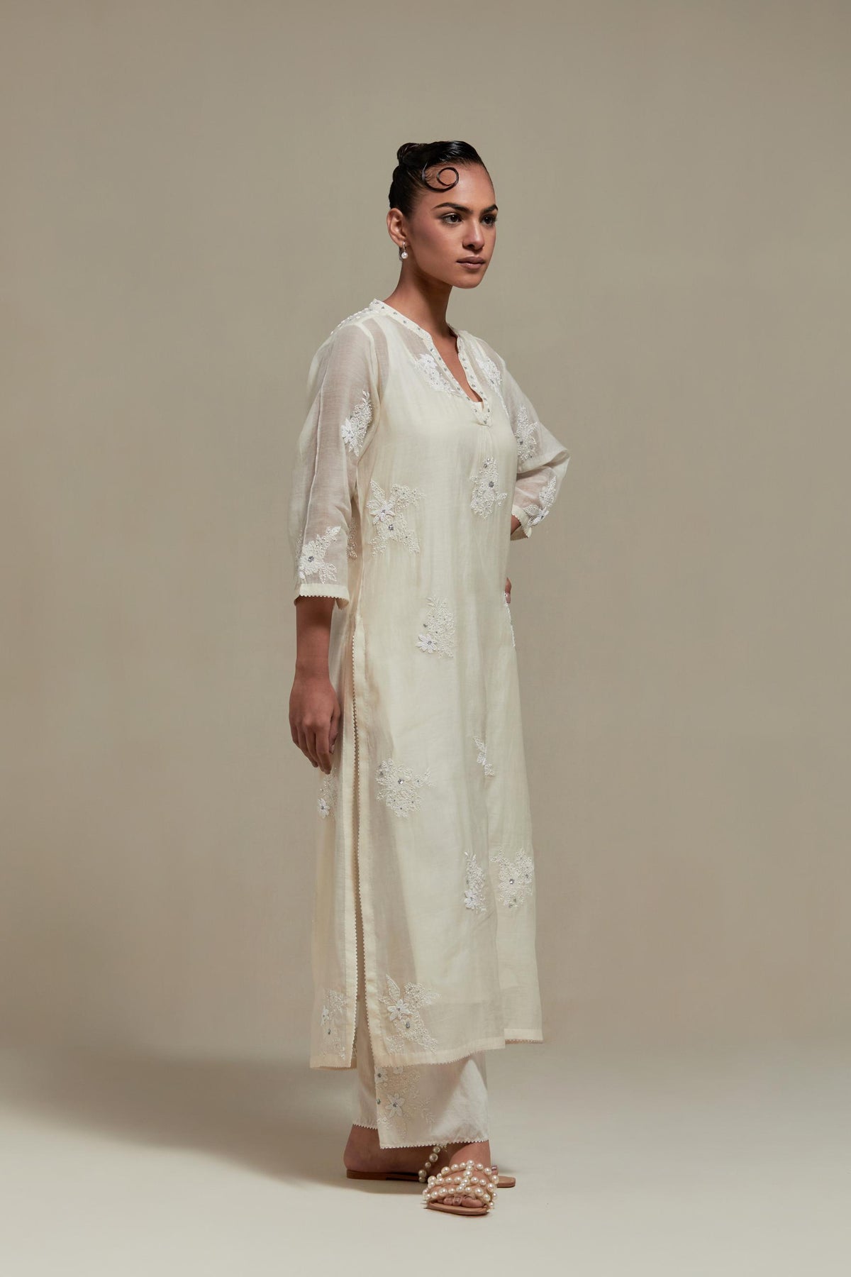 Off white cotton Chanderi straight kurta set with randomly placed appliquéd flowers, highlighted with sequins and beads.