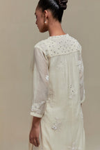 Off white cotton Chanderi straight kurta set with randomly placed appliquéd flowers, highlighted with sequins and beads.