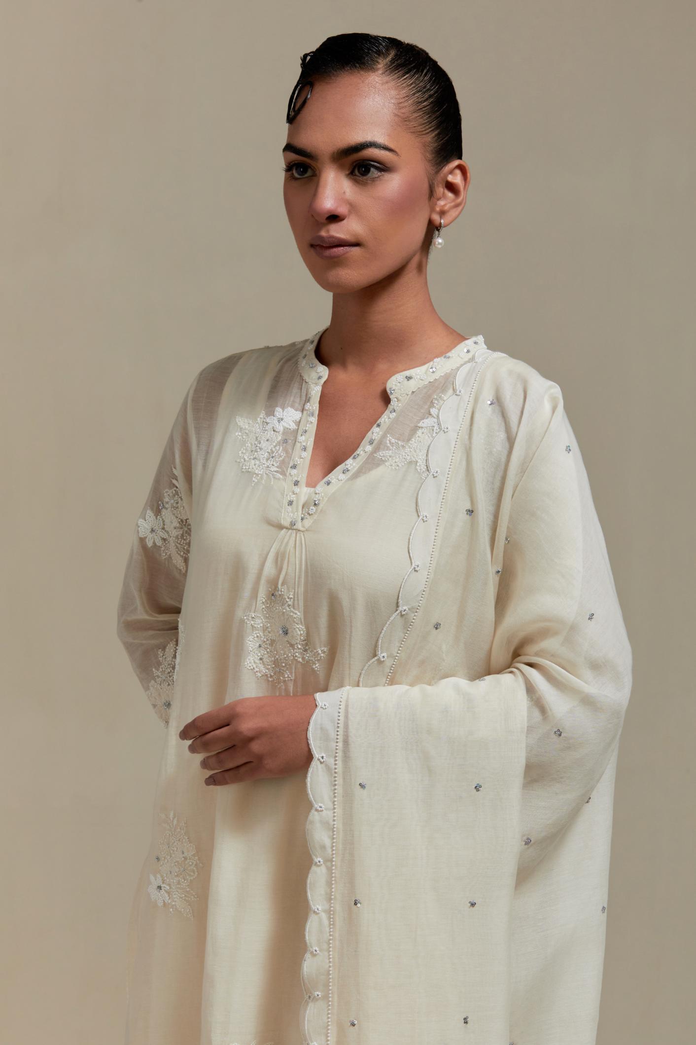 Off white cotton Chanderi dupatta, highlighted with all-over delicate sequins flower and appliqué motifs at dupatta corners.