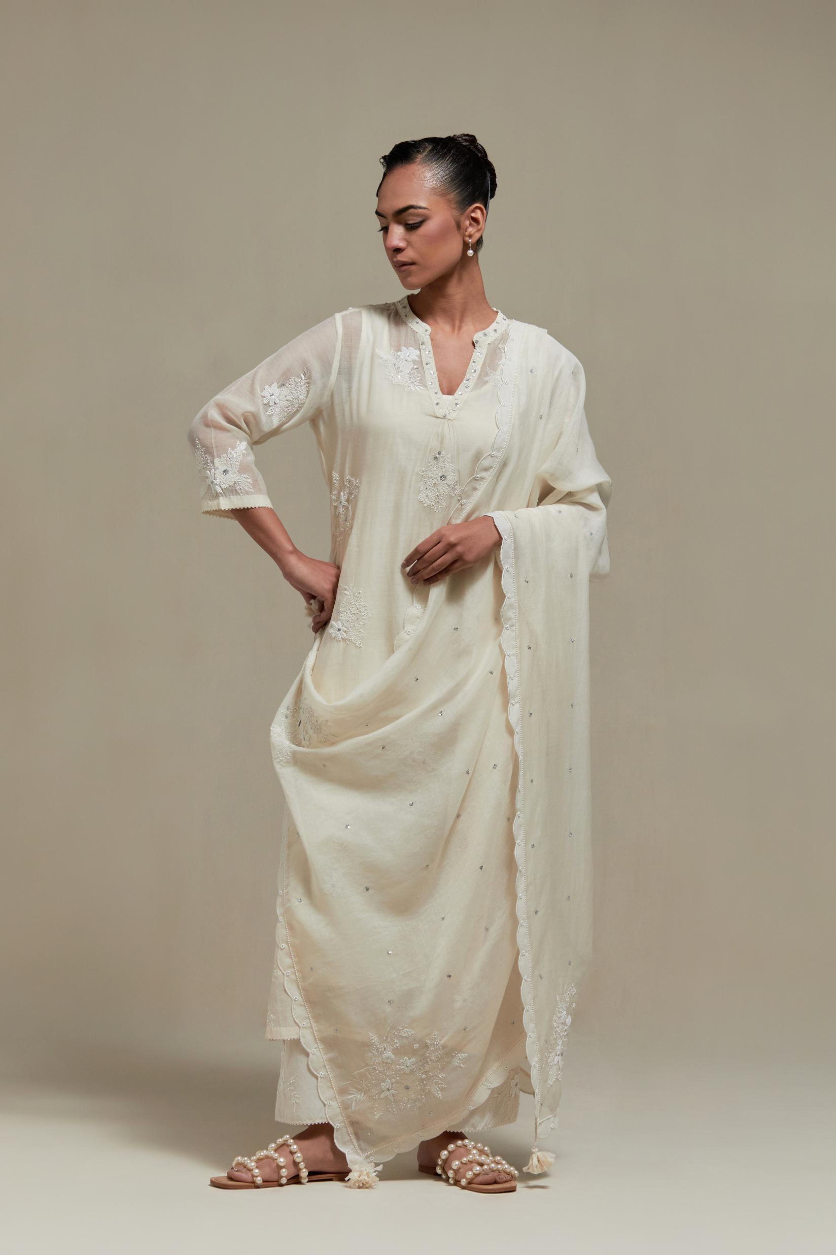 Off white cotton Chanderi dupatta, highlighted with all-over delicate sequins flower and appliqué motifs at dupatta corners.