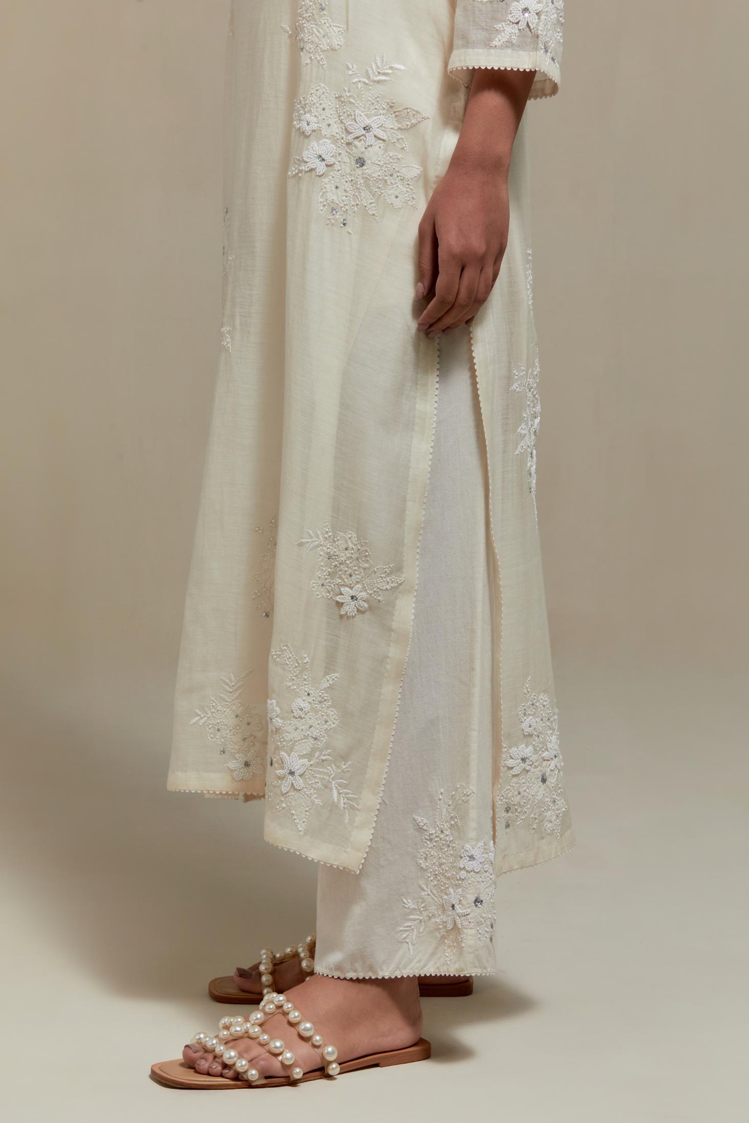 Off white cotton Chanderi short kurta set with all-over appliqué, highlighted with sequins and beads.