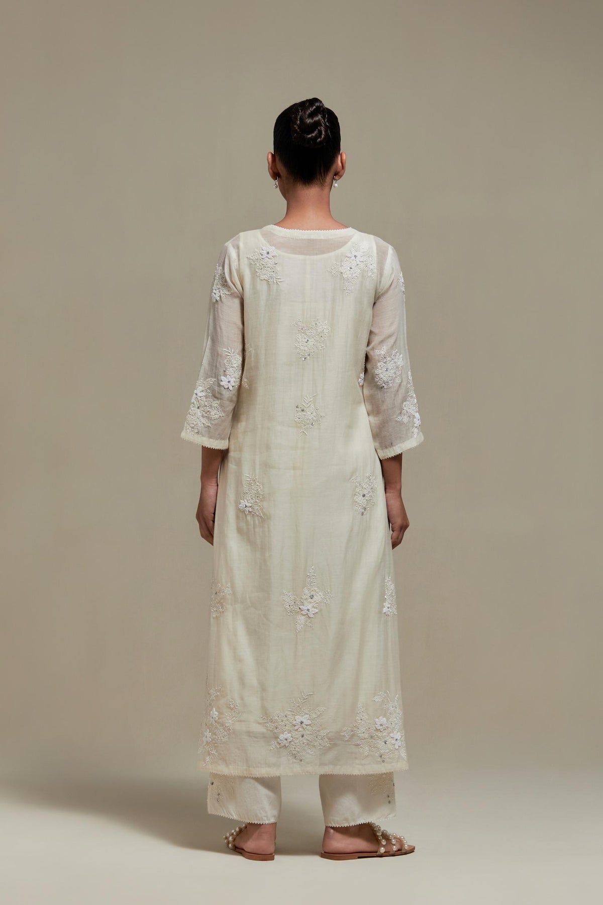 Off white straight kurta set with all-over appliqué motifs, highlighted with sequins and beads.
