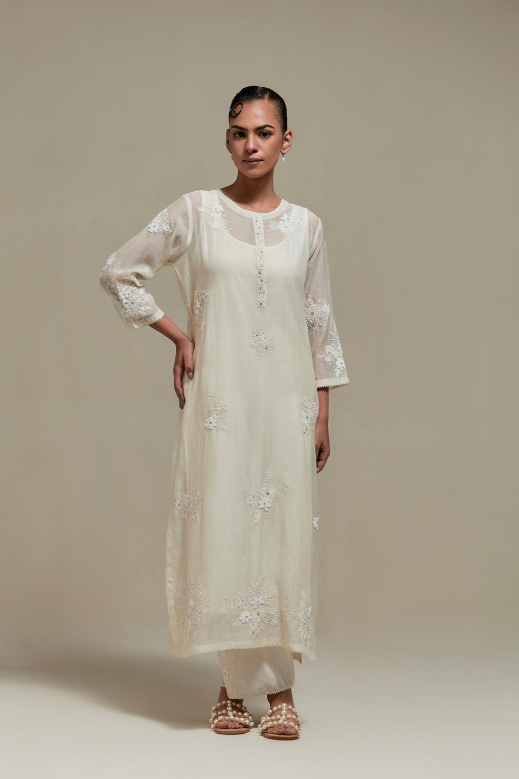 Off white straight kurta set with all-over appliqué motifs, highlighted with sequins and beads.