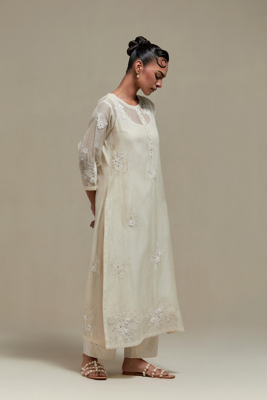 Off white straight kurta set with all-over appliqué motifs, highlighted with sequins and beads.