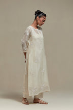 Off white straight kurta set with all-over appliqué motifs, highlighted with sequins and beads.