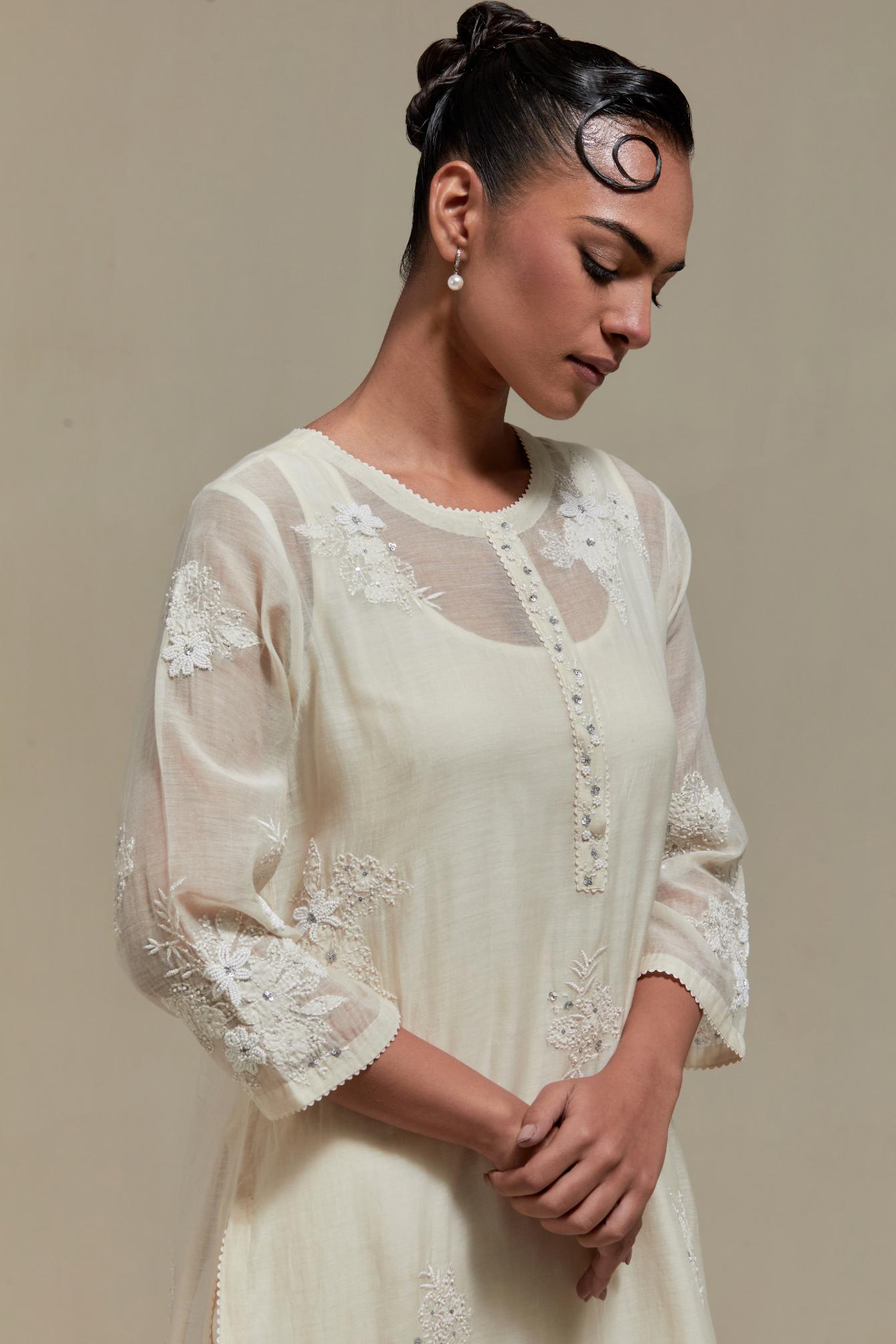 Off white straight kurta set with all-over appliqué motifs, highlighted with sequins and beads.