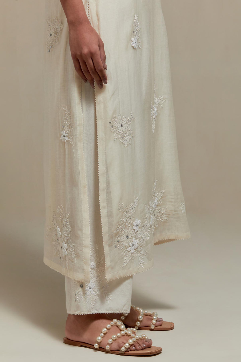 Off white straight kurta set with all-over appliqué motifs, highlighted with sequins and beads.