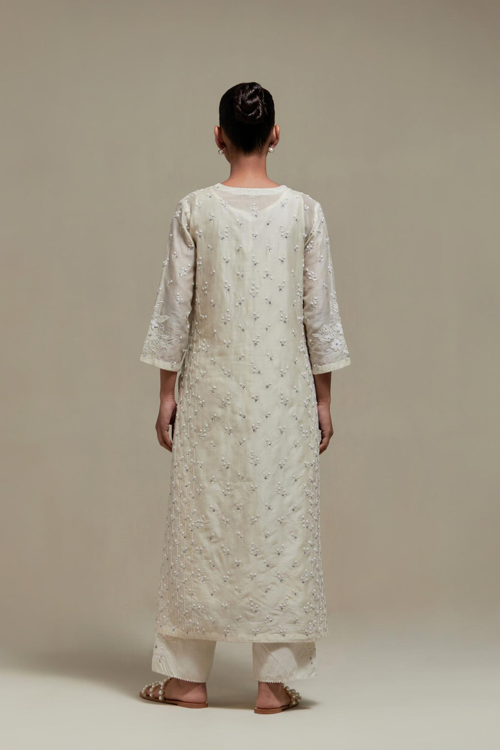 Off white silk Chanderi straight kurta set with all-over delicate embroidered flowers, highlighted with sequins and beads.