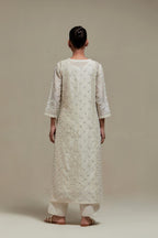 Off white silk Chanderi straight kurta set with all-over delicate embroidered flowers, highlighted with sequins and beads.
