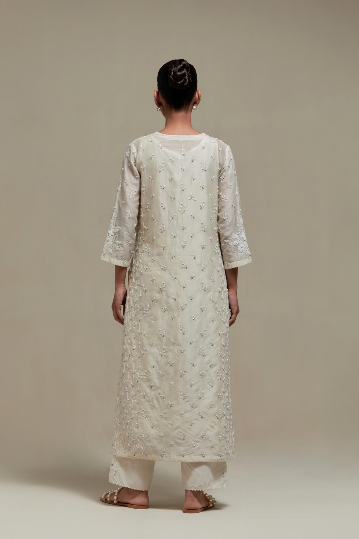 Off white silk Chanderi straight kurta set with all-over delicate embroidered flowers, highlighted with sequins and beads.