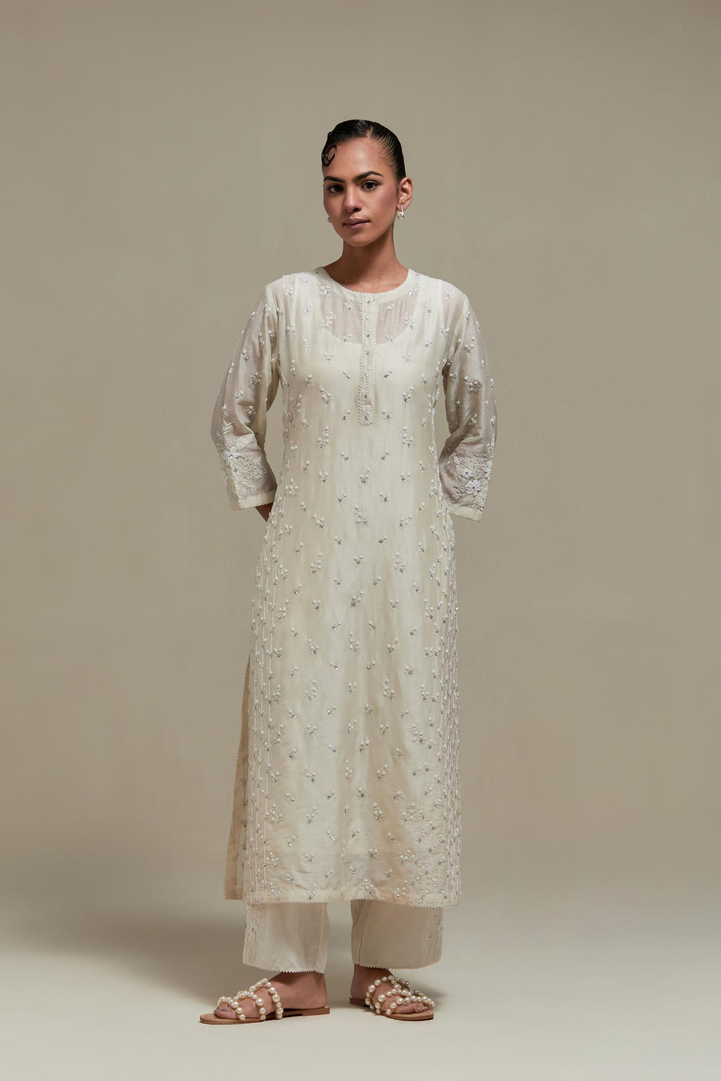 Off white silk Chanderi straight kurta set with all-over delicate embroidered flowers, highlighted with sequins and beads.
