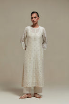 Off white silk Chanderi straight kurta set with all-over delicate embroidered flowers, highlighted with sequins and beads.