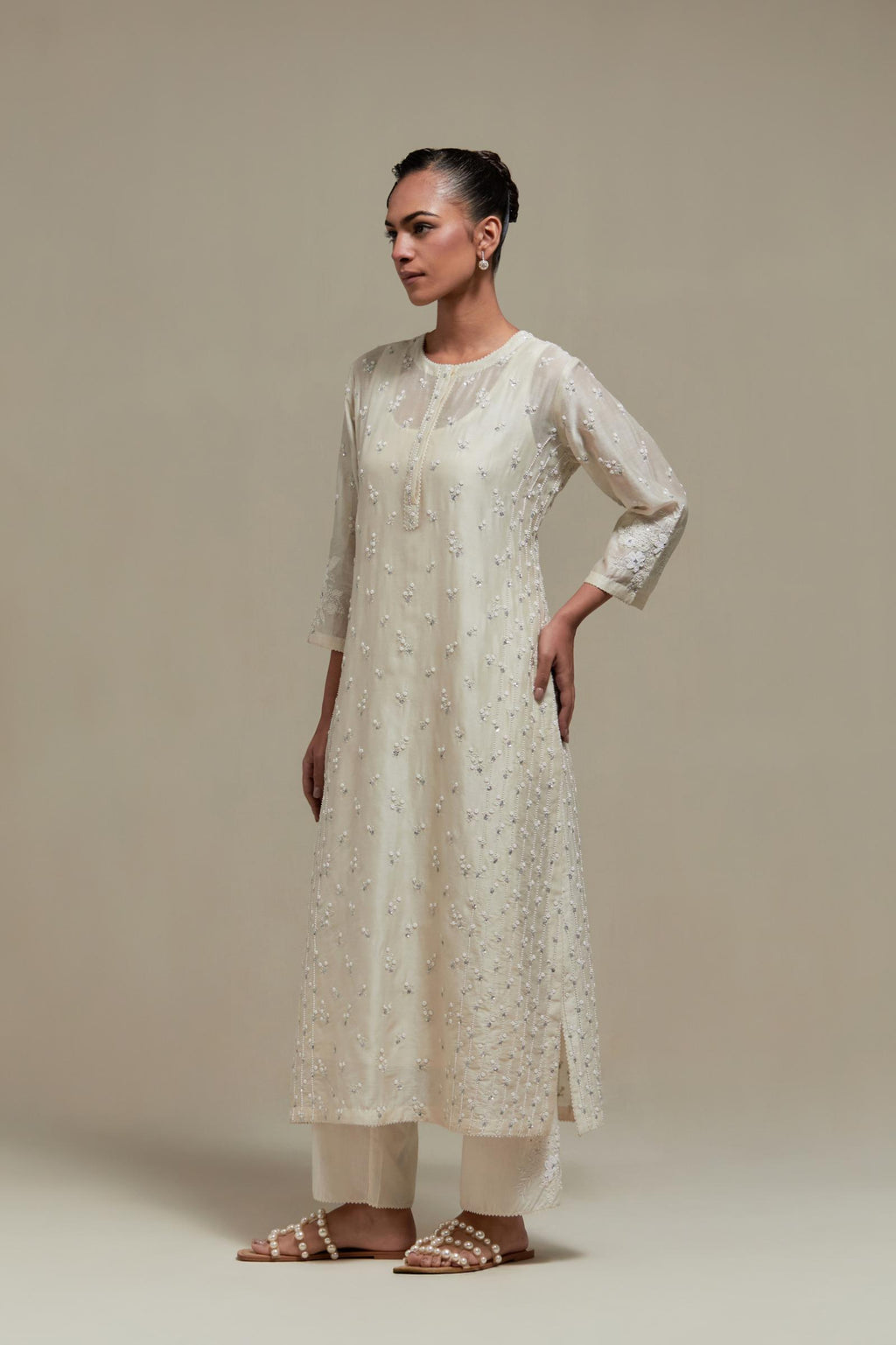 Off white silk Chanderi straight kurta set with all-over delicate embroidered flowers, highlighted with sequins and beads.