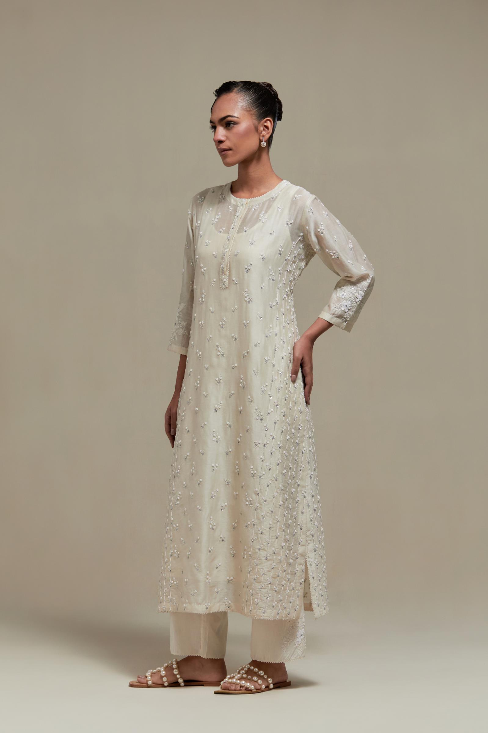 Off white silk Chanderi straight kurta set with all-over delicate embroidered flowers, highlighted with sequins and beads.