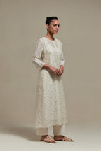 Off white silk Chanderi straight kurta set with all-over delicate embroidered flowers, highlighted with sequins and beads.