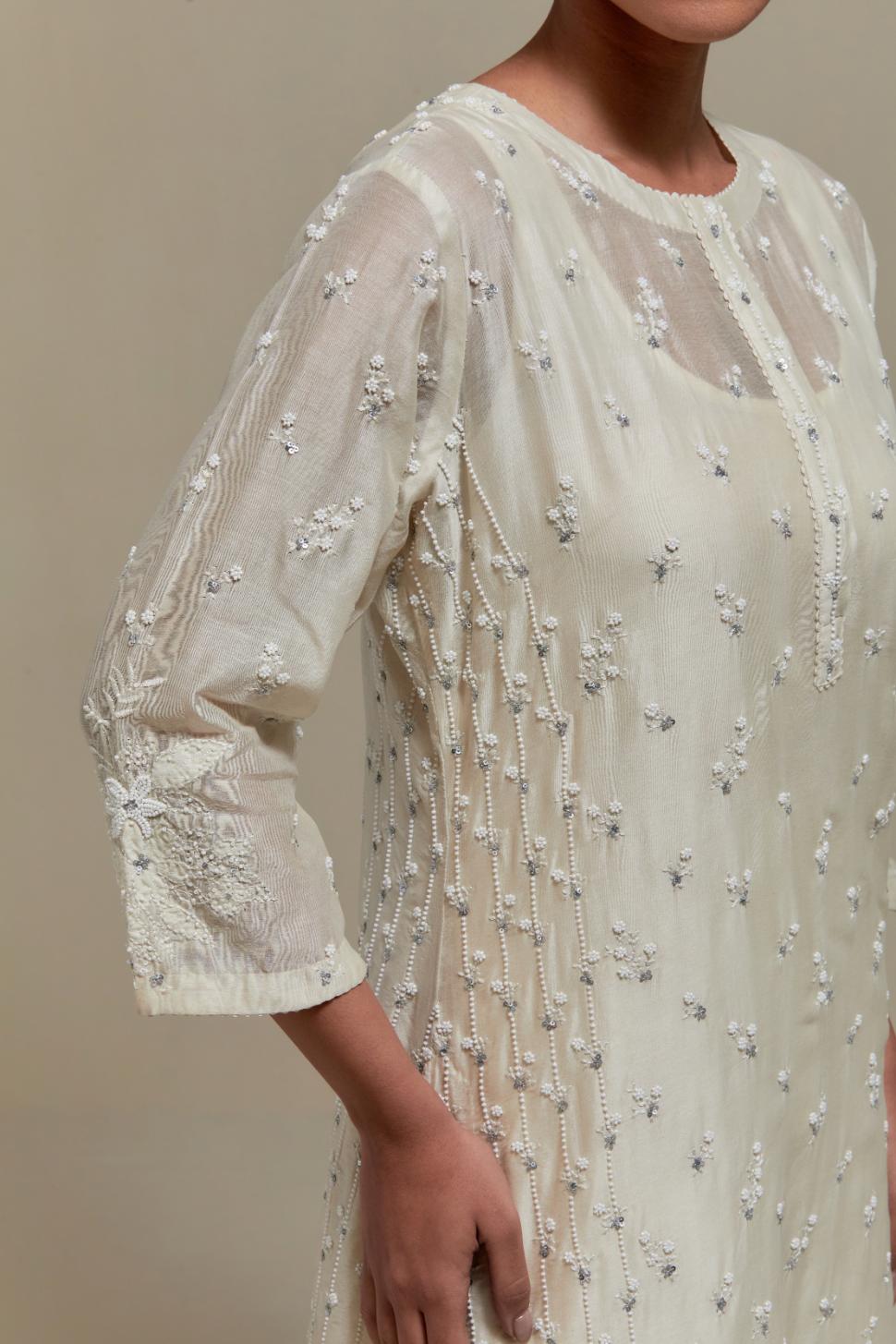 Off white silk Chanderi straight kurta set with all-over delicate embroidered flowers, highlighted with sequins and beads.