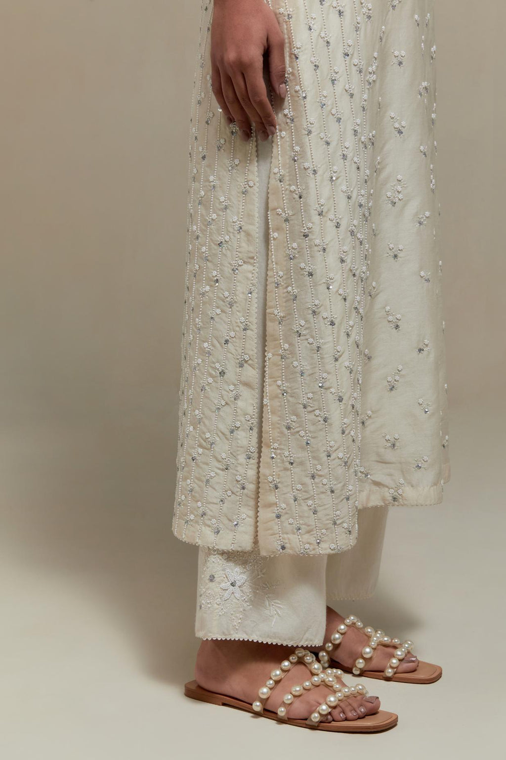 Off white silk Chanderi straight kurta set with all-over delicate embroidered flowers, highlighted with sequins and beads.