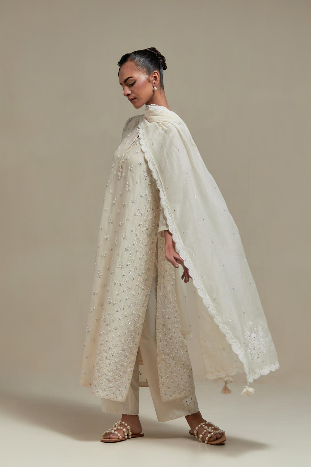 Off white silk Chanderi straight kurta set with all-over delicate embroidered flowers, highlighted with sequins and beads.