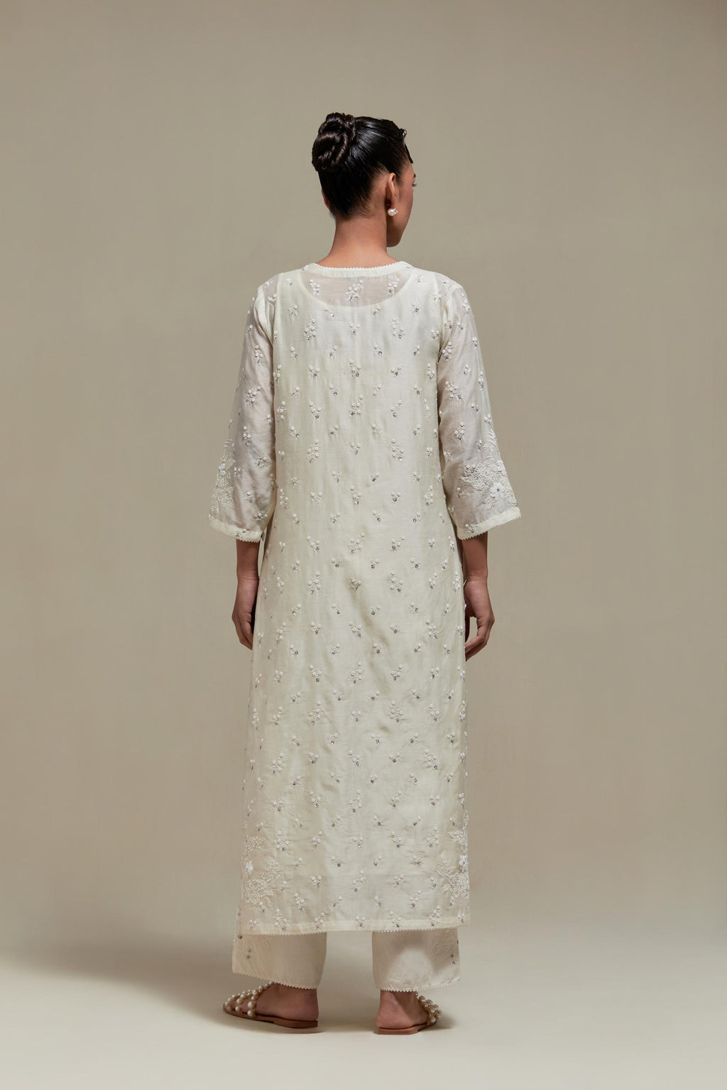 Off white silk Chanderi straight kurta set with all-over delicate embroidered flowers, highlighted with sequins and beads.